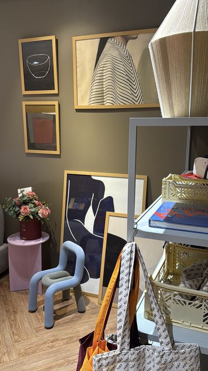 Framed prints and design objects in a studio corner